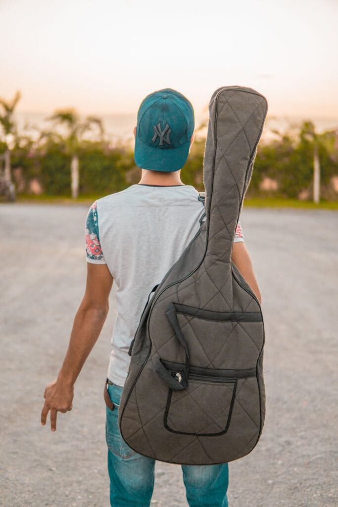 pexels-photo-632700 Selective Focus Photography of Man Holding Gig Bag